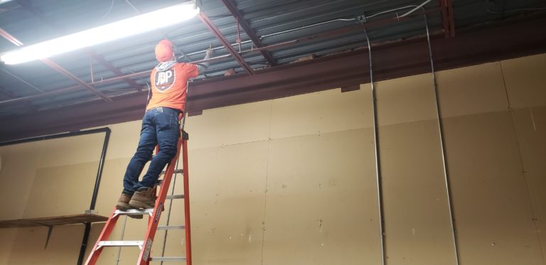 electrician working on repair in a commercial building